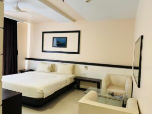 Superior King Bedroom-romm-new with a large bed, modern decor, and a city view through large windows
